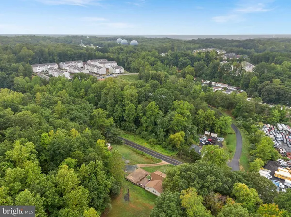 an aerial view of residential house with outdoor space and trees