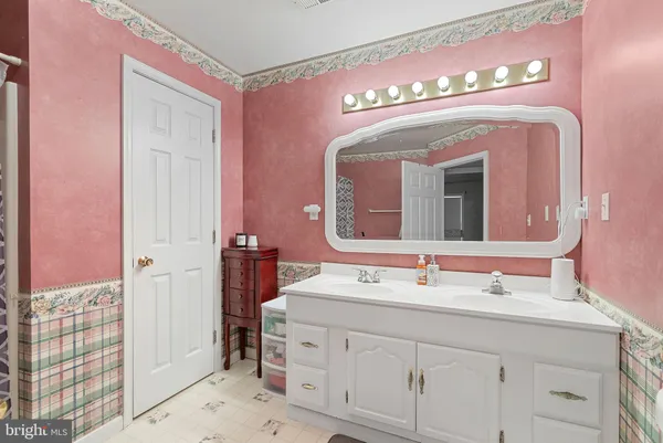 a view of an empty room with stairs and white walls