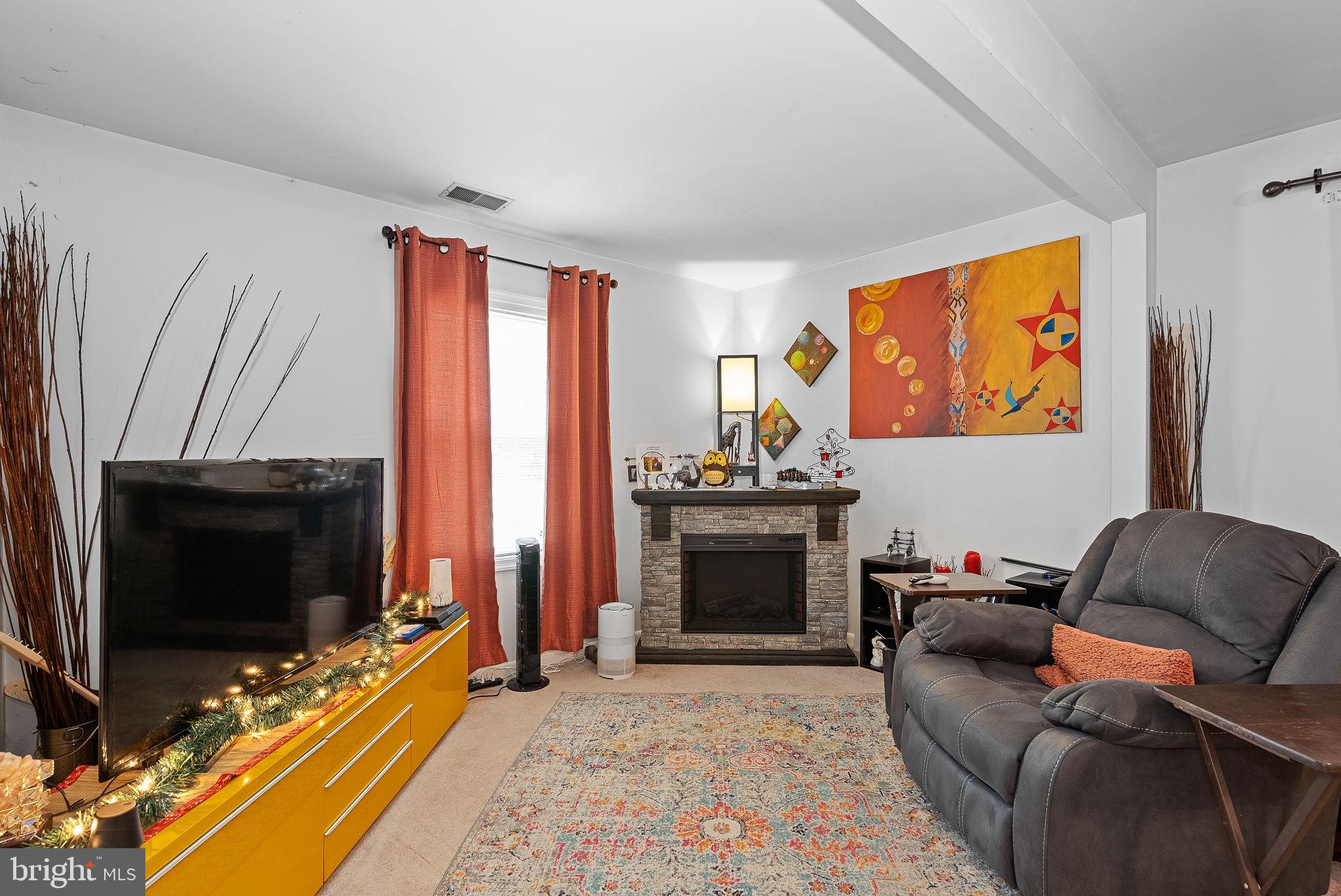 804 Telegraph Road Stafford, VA 22554 - Photo 32 of 39 a living room with furniture a flat screen tv and a fireplace