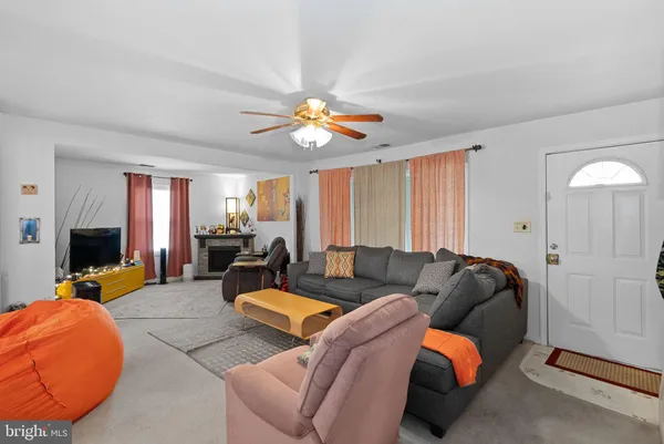 a living room with furniture a couch and a chandelier