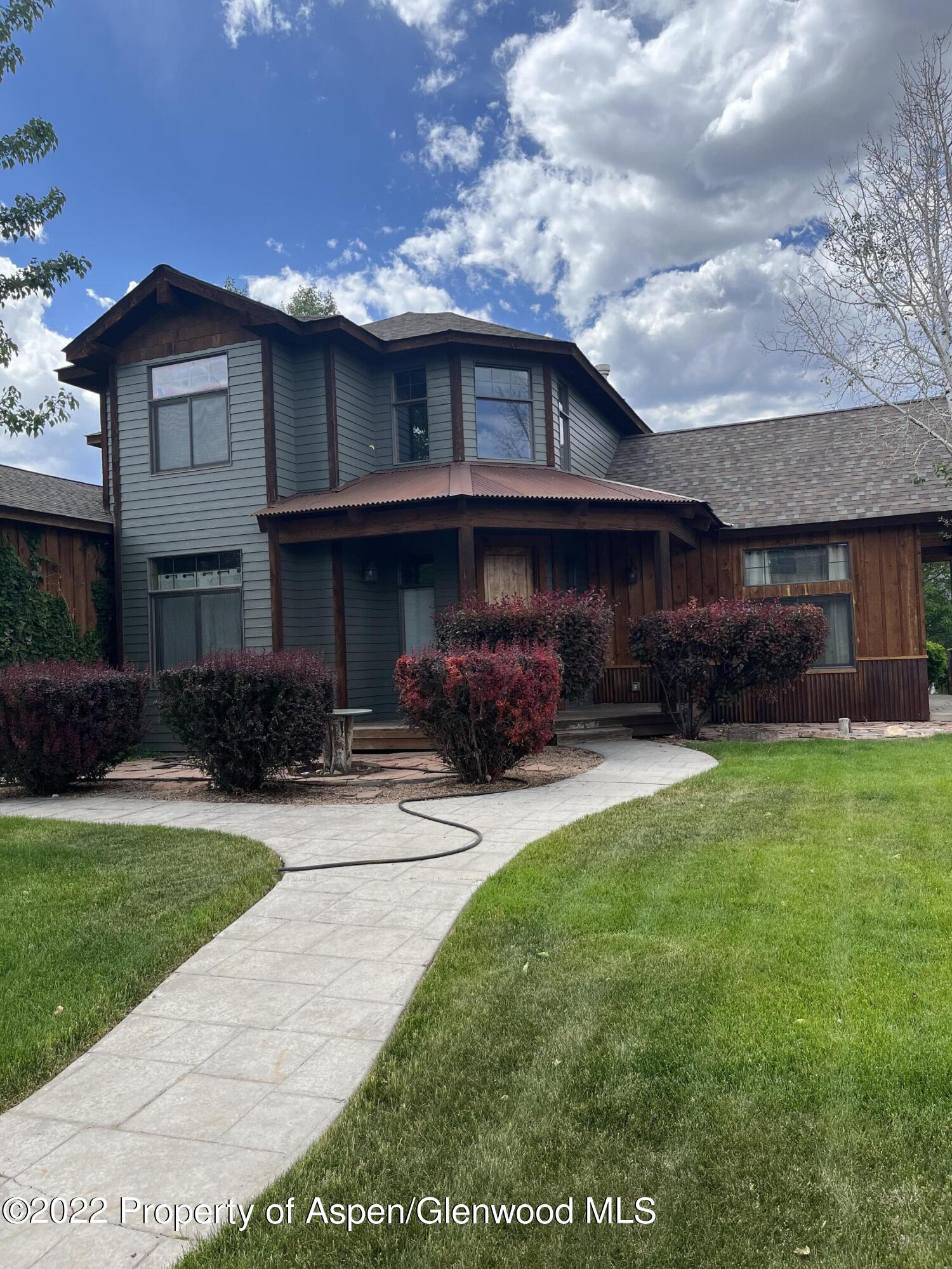 1310 West Spruce Court Rifle, CO 81650 - Photo 1 of 1 a front view of a house with a garden and plants