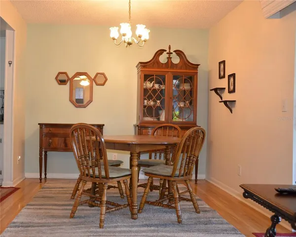 a view of a dining room with furniture wooden floor and a chandelier