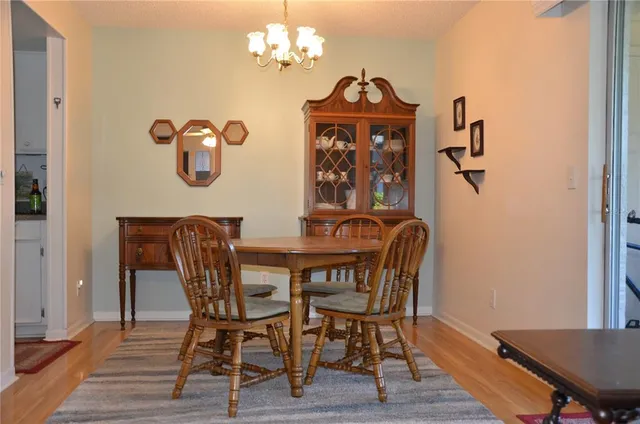 a view of a dining room with furniture wooden floor and a chandelier