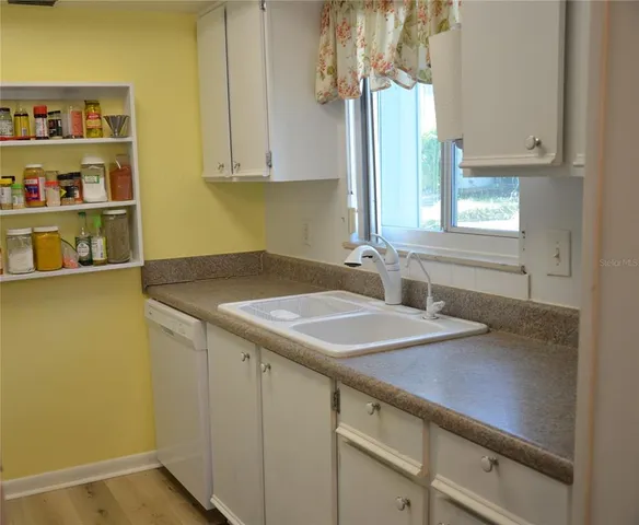 a kitchen with a sink and cabinets