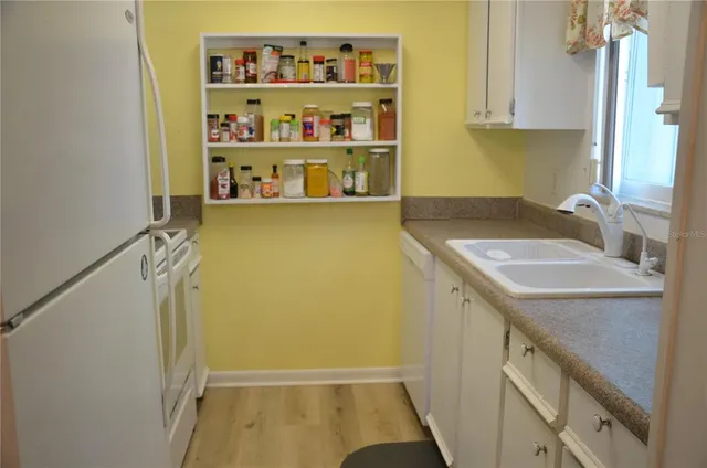 a bathroom with a sink a vanity and a shower