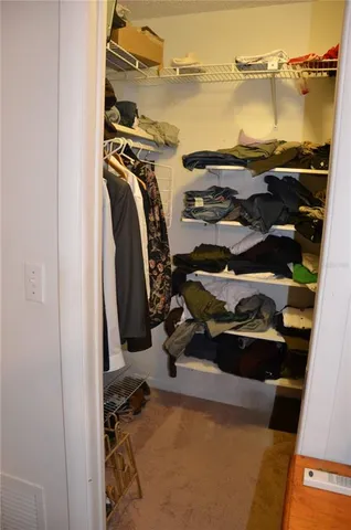 a bedroom with a bed and a dresser in it