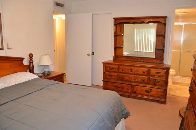 a bedroom with a bed and a dresser in it