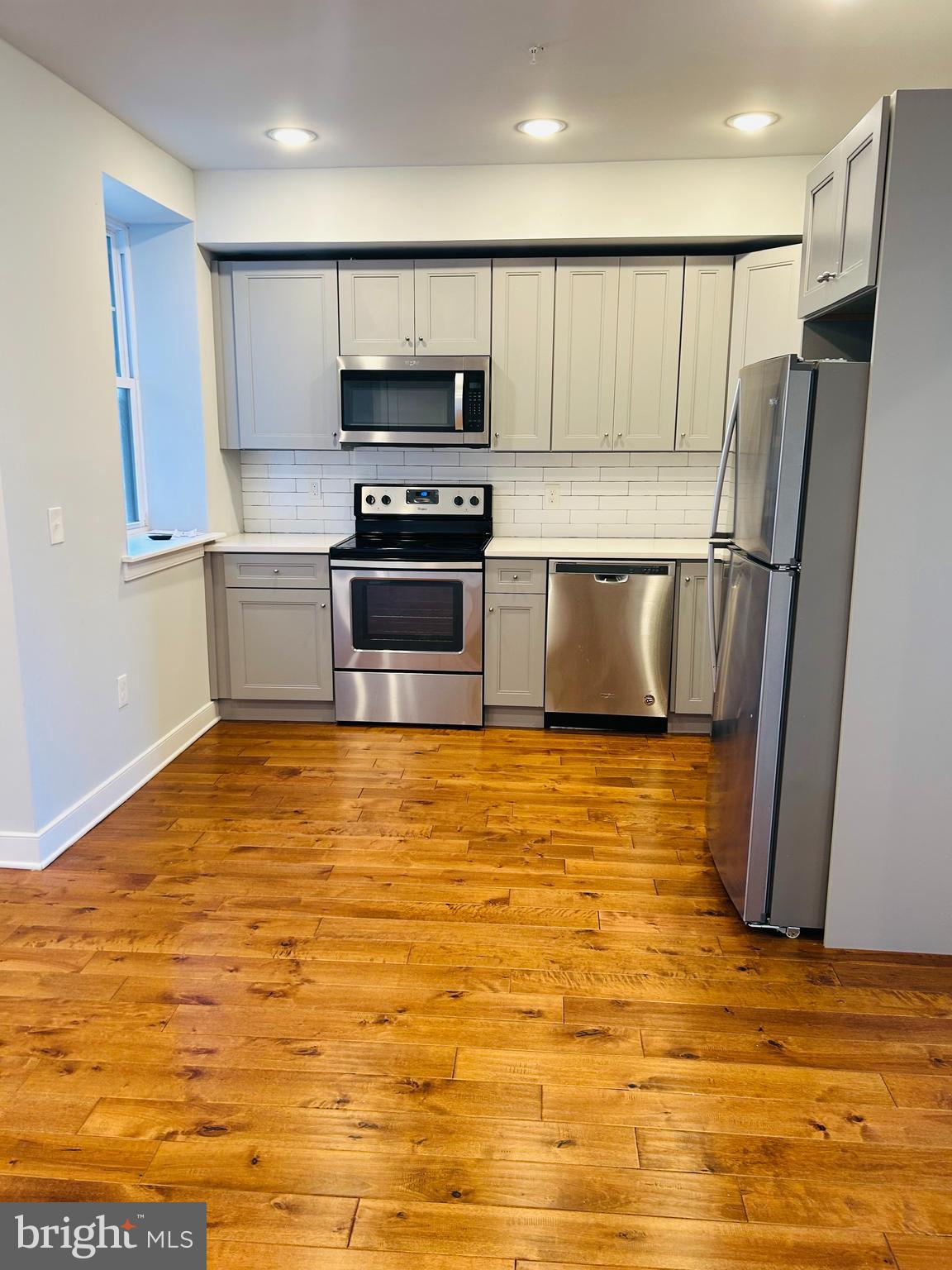 6090 Drexel Road, Unit 3 Philadelphia, PA 19131 - Photo 5 of 10 a kitchen with stainless steel appliances a refrigerator a stove top oven a sink and a refrigerator