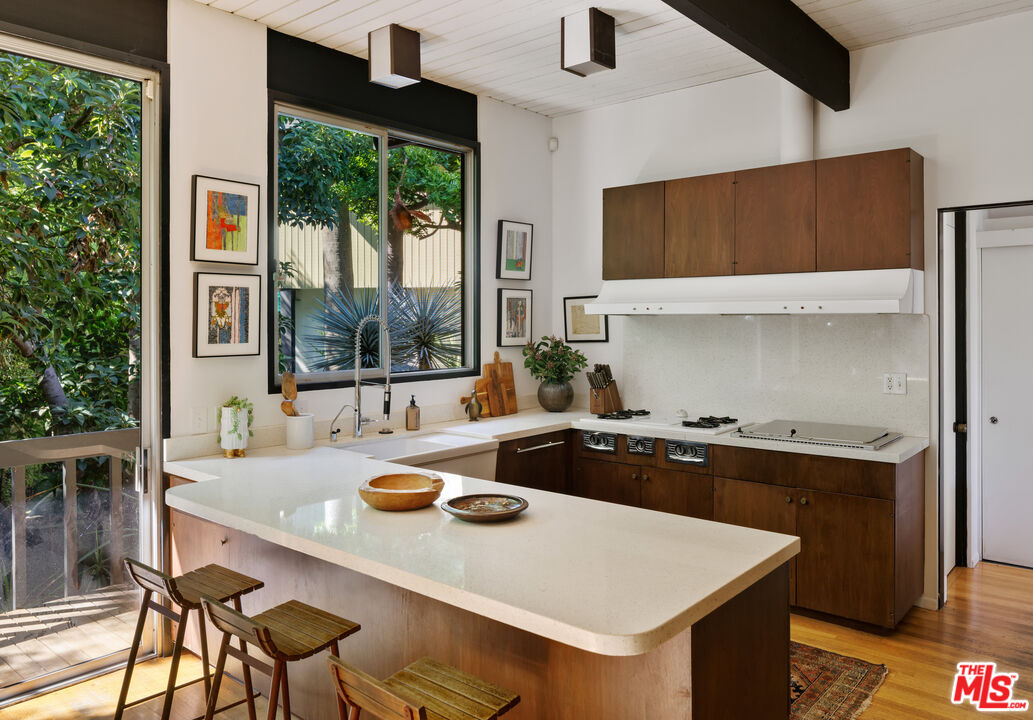 4520 Dundee Drive Los Angeles, CA 90027 - Photo 17 of 63 a kitchen with a stove a sink and a refrigerator