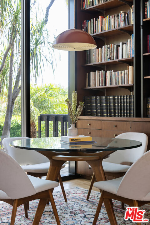 4520 Dundee Drive Los Angeles, CA 90027 - Photo 23 of 63 a dining room with furniture and a floor to ceiling window