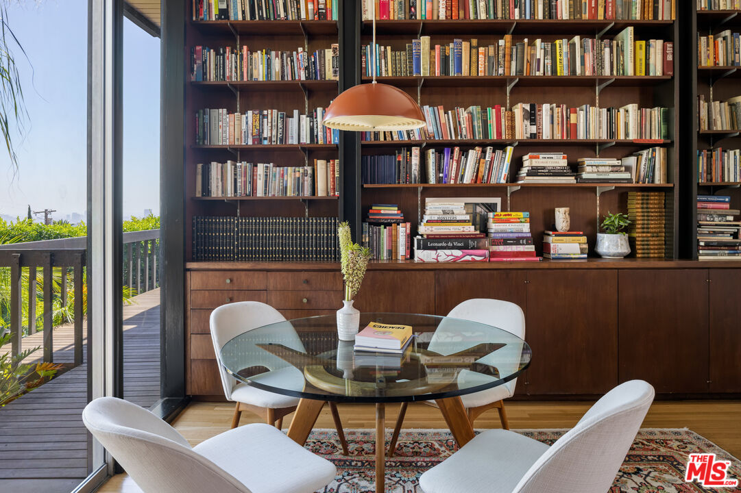 4520 Dundee Drive Los Angeles, CA 90027 - Photo 24 of 63 a work room with furniture a bookshelf and a book shelf