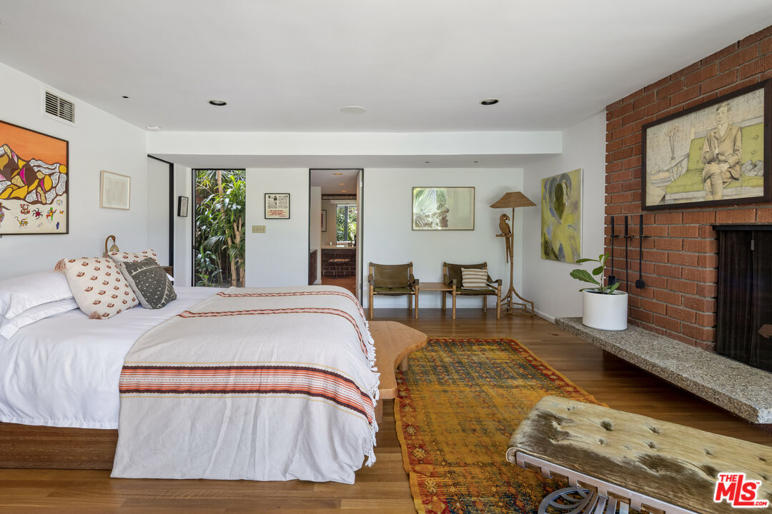 4520 Dundee Drive Los Angeles, CA 90027 - Photo 31 of 63 a spacious bedroom with a bed a dresser next to a window