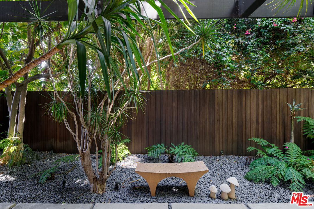 4520 Dundee Drive Los Angeles, CA 90027 - Photo 46 of 63 a view of a backyard with potted plants and large tree