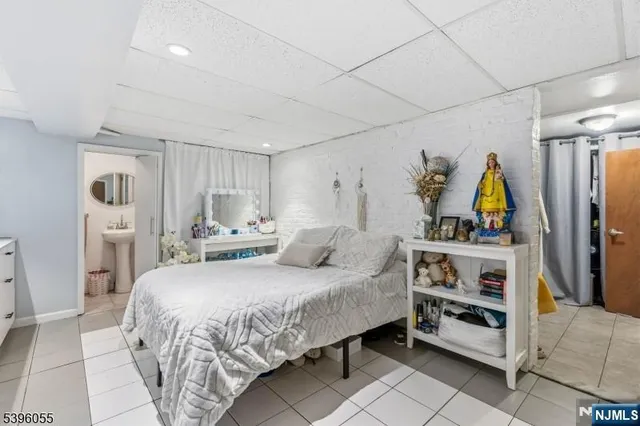a bedroom with a bed furniture and a flat screen tv