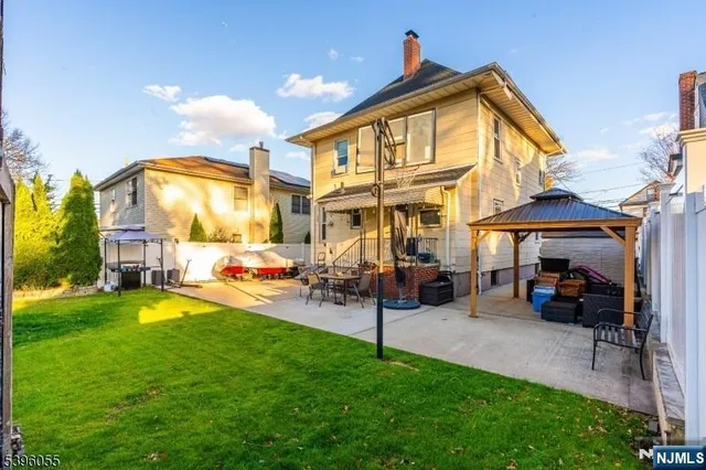 a view of a backyard with table and chairs a barbeque