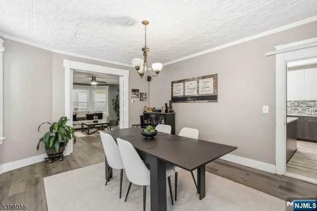 a view of a dining room with furniture and chandelier