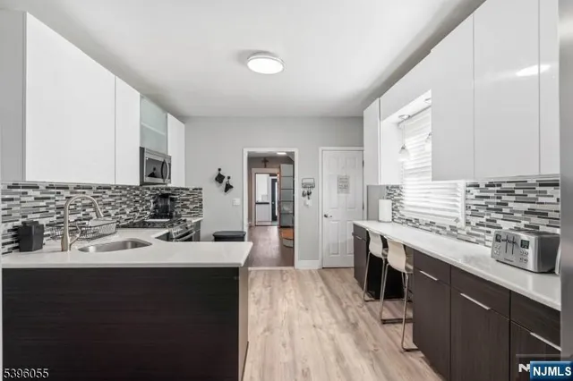 a kitchen with a sink stove and cabinets