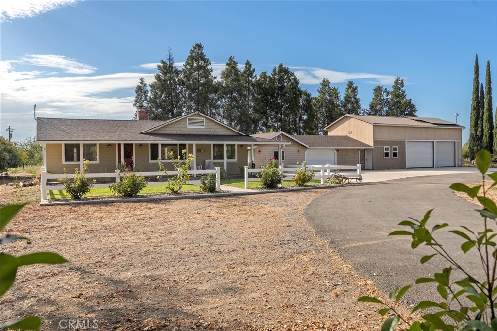 a front view of a residential houses with yard and green space