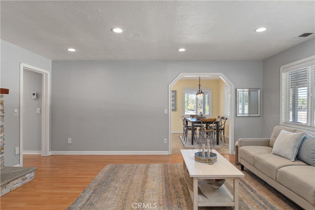 8683 Sullivan Way Durham, CA 95938 - Photo 11 of 32 a living room with fireplace furniture and a wooden floor