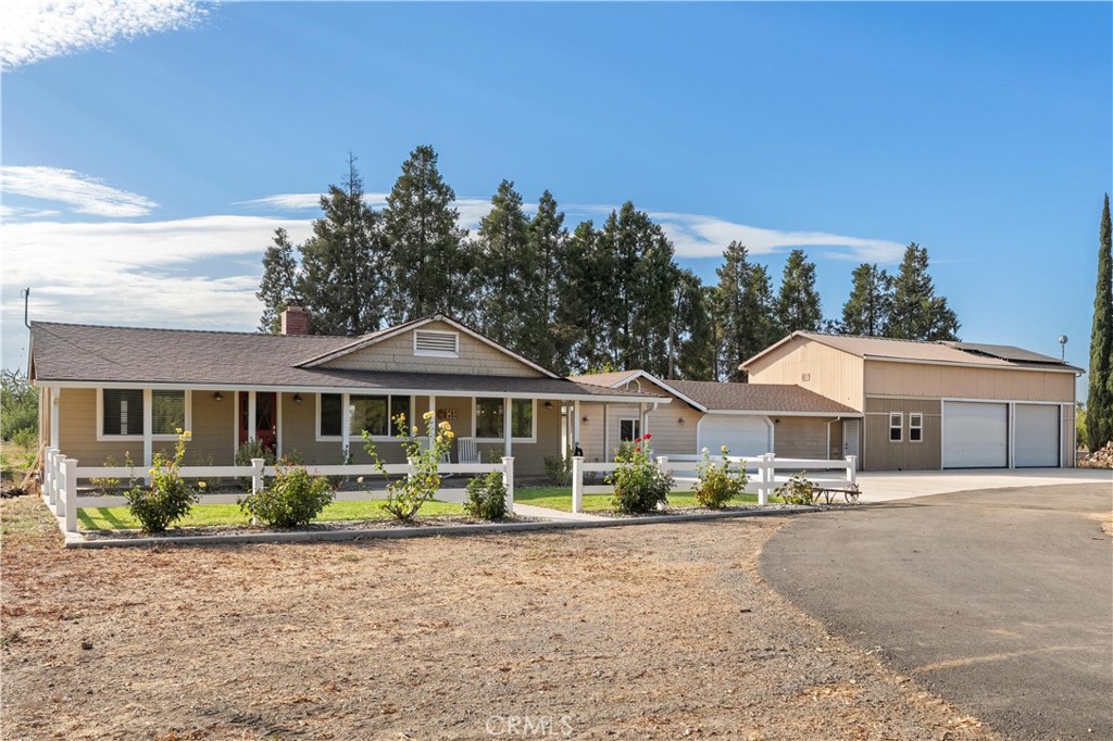 8683 Sullivan Way Durham, CA 95938 - Photo 2 of 32 a front view of a house with a yard and potted plants