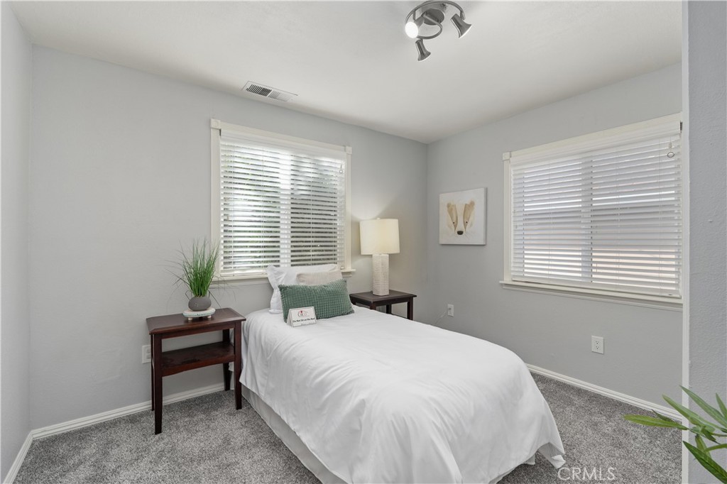 8683 Sullivan Way Durham, CA 95938 - Photo 21 of 32 a bedroom with a bed and a window