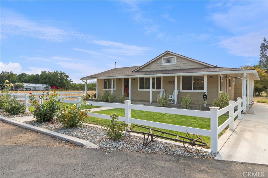8683 Sullivan Way Durham, CA 95938 - Photo 3 of 32 a front view of a house with a yard table and chairs