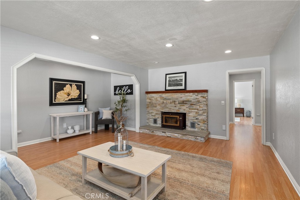 8683 Sullivan Way Durham, CA 95938 - Photo 9 of 32 a living room with furniture a fireplace and a table