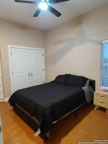 a bedroom with a bed and window