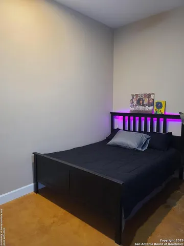 a living room with a bed and a table