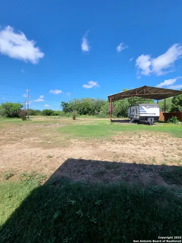 a view of a field with an ocean