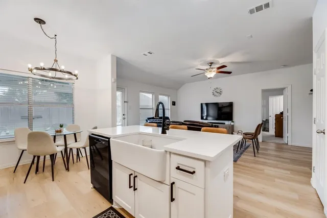 a view of kitchen with cabinets table and chairs