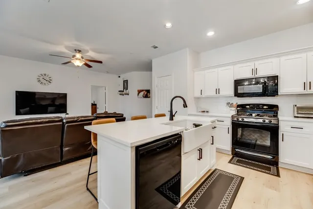 a kitchen with a stove a sink and a microwave