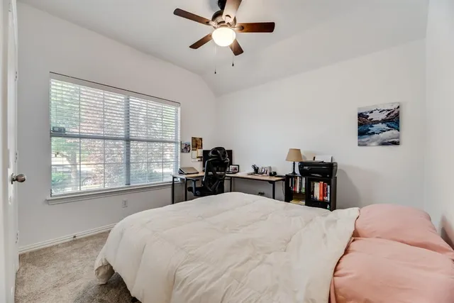 a bed room with a bed and a chair