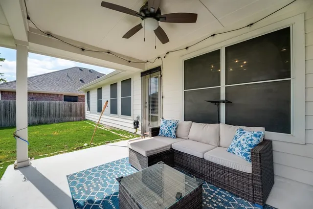 a balcony with furniture and a yard
