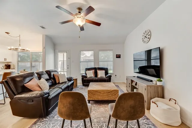 a living room with furniture and a flat screen tv