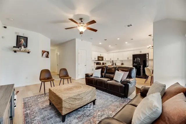 a living room with furniture and a lamp
