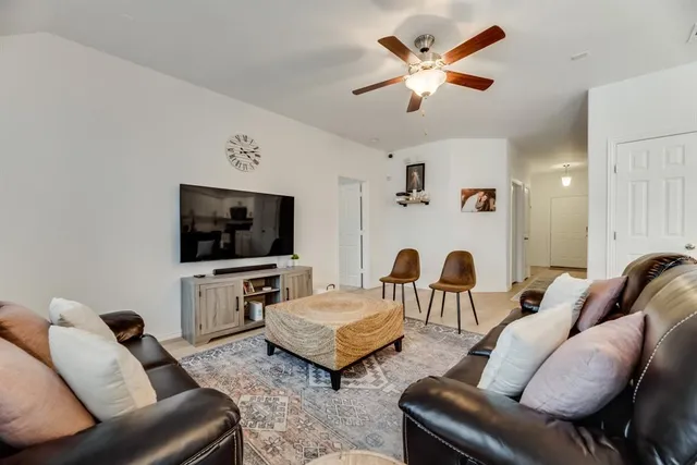 a living room with furniture and a flat screen tv