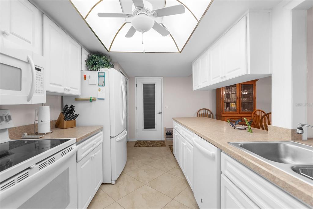 6409 Wedgewood Drive Spring Hill, FL 34606 - Photo 15 of 38 a large white kitchen with a sink and cabinets