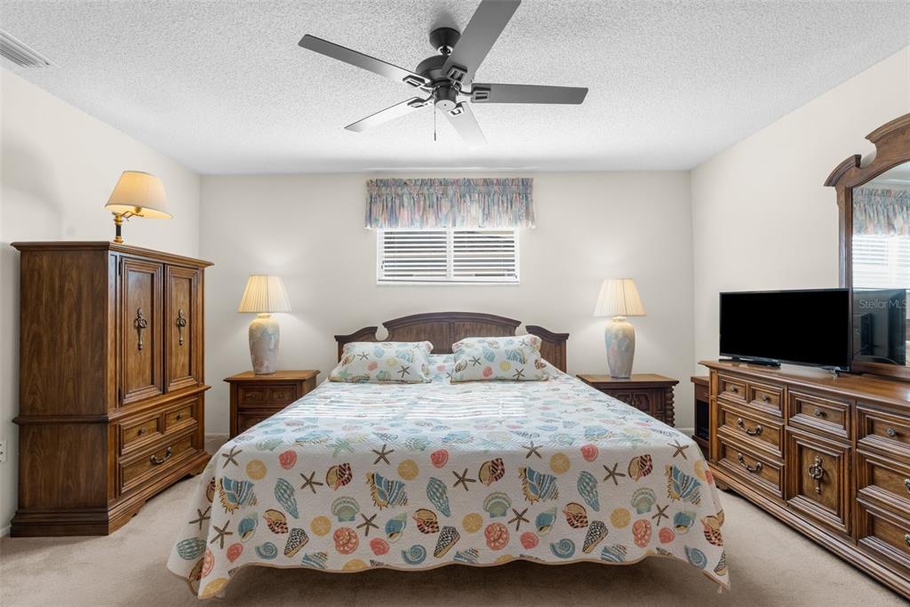 6409 Wedgewood Drive Spring Hill, FL 34606 - Photo 18 of 38 a bedroom with a bed and a flat screen tv