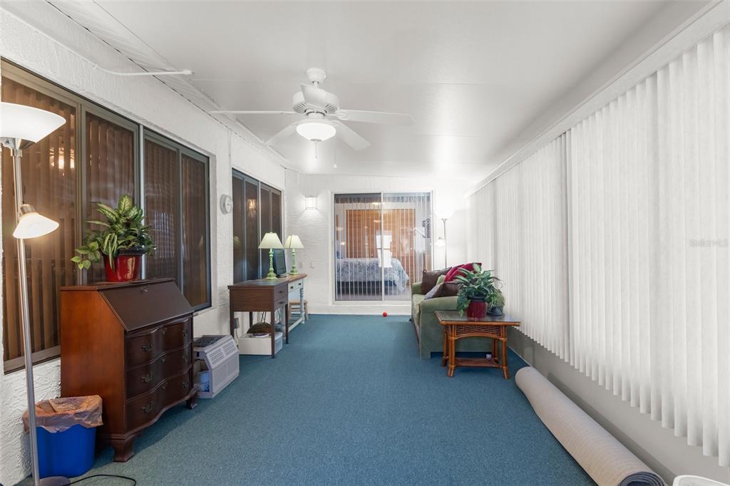 6409 Wedgewood Drive Spring Hill, FL 34606 - Photo 26 of 38 a living room with furniture and a chandelier