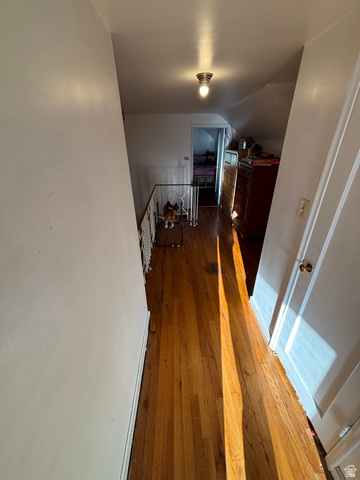 102 South Main Street Paris, ID 83261 - Photo 25 of 33 Hall with dark wood-style flooring, lofted ceiling, and an upstairs landing