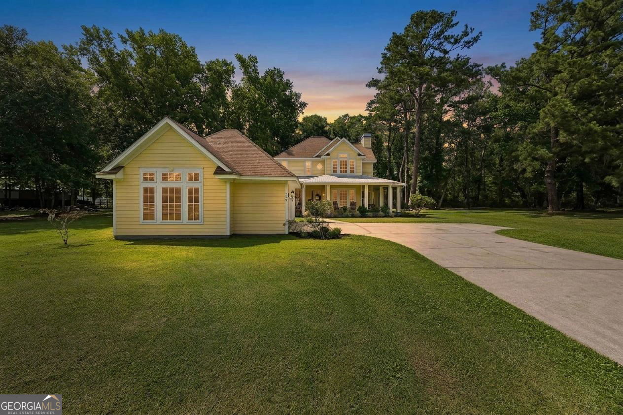 706 Hopewell Point Road White Oak, GA 31568 - Photo 51 of 84 Welcome home to 706 Hopewell Point Rd. Warm evening tones, mature trees, and timeless Southern architecture create a memorable first impression.