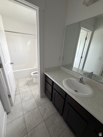 878 West Mckenna Road Bluffdale, UT 84065 - Photo 9 of 11 White tile flooring with a dark wood-finish vanity, light-toned countertop, and integrated sink
