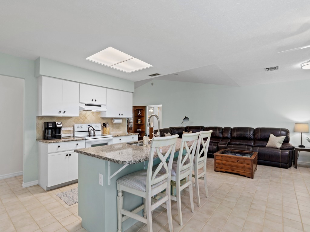 765 Date Palm Road Vero Beach, FL 32963 - Photo 10 of 36 a kitchen with a stove a sink and a refrigerator