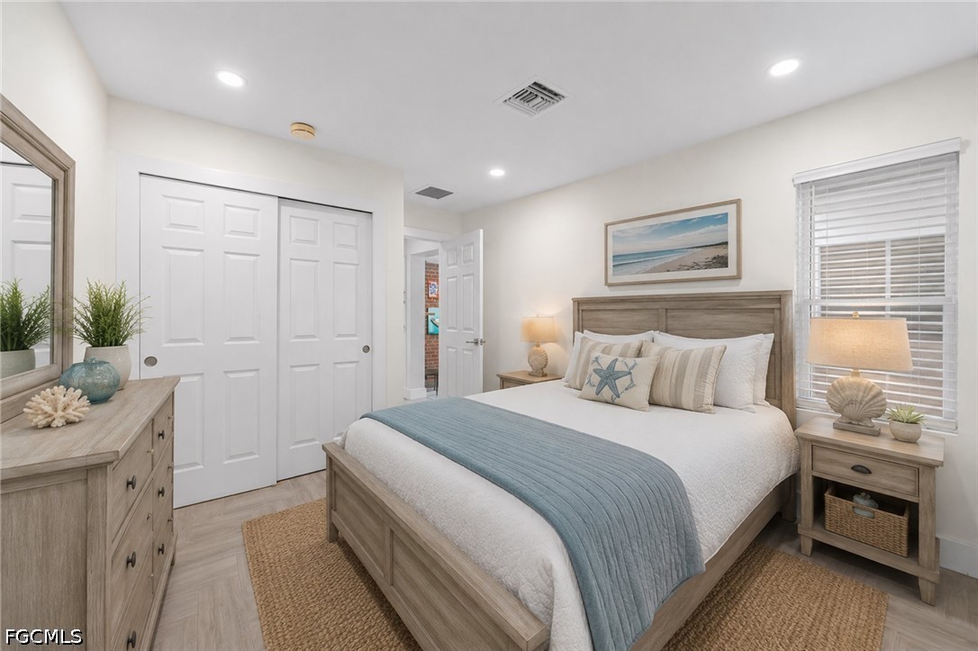 1200 Patterson Road Cape Coral, FL 33909 - Photo 19 of 42 a spacious bedroom with a bed and a couch
