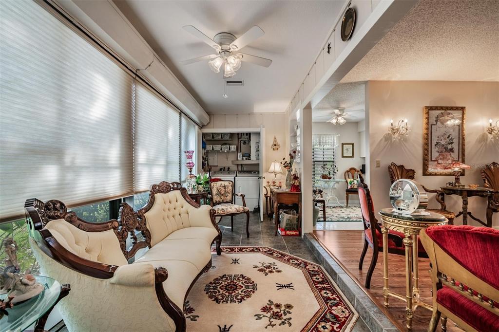 9302 Trowbridge Court New Port Richey, FL 34655 - Photo 13 of 41 a living room with furniture and a chandelier