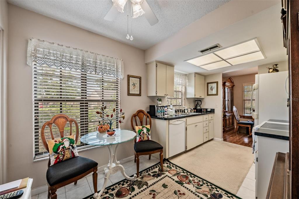 9302 Trowbridge Court New Port Richey, FL 34655 - Photo 15 of 41 a kitchen with stainless steel appliances granite countertop a stove a sink dishwasher and white cabinets with wooden floor