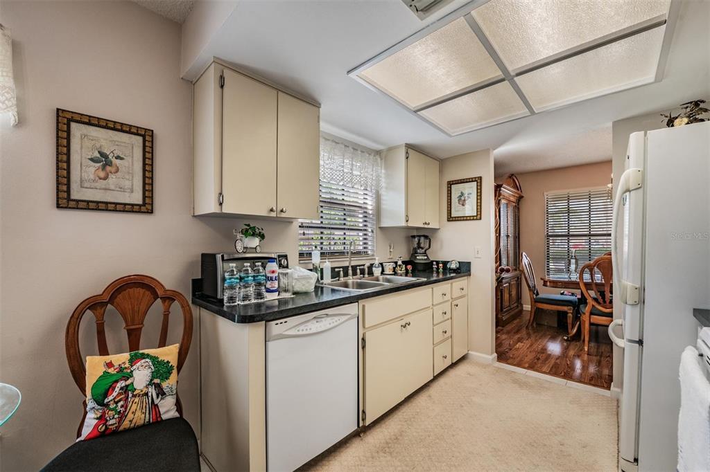 9302 Trowbridge Court New Port Richey, FL 34655 - Photo 17 of 41 a kitchen that has a lot of cabinets a sink and a stove