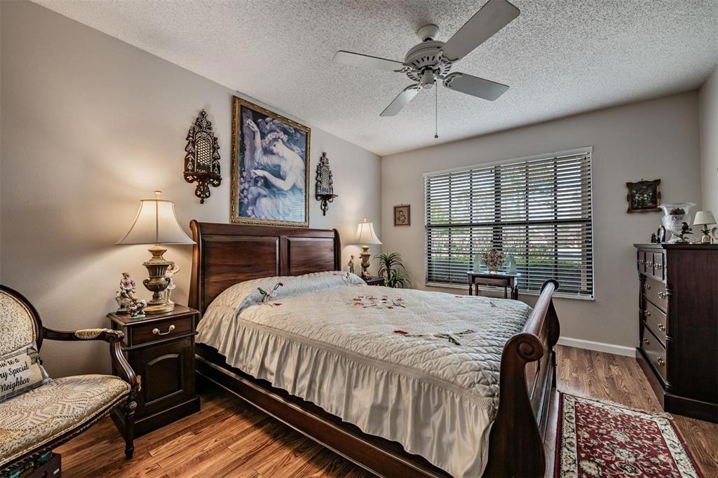 9302 Trowbridge Court New Port Richey, FL 34655 - Photo 19 of 41 a bedroom with a bed and wooden floor