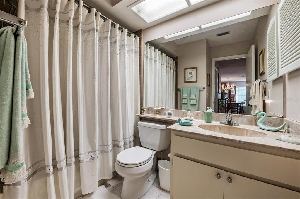 9302 Trowbridge Court New Port Richey, FL 34655 - Photo 21 of 41 a bathroom with a double vanity sink toilet and a mirror